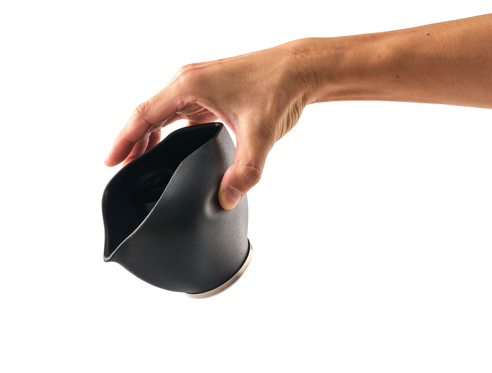 Hand pouring from a black matcha bowl. Elevate Your Cafe: Barista-Quality Matcha Frother & Wholesale Supplies